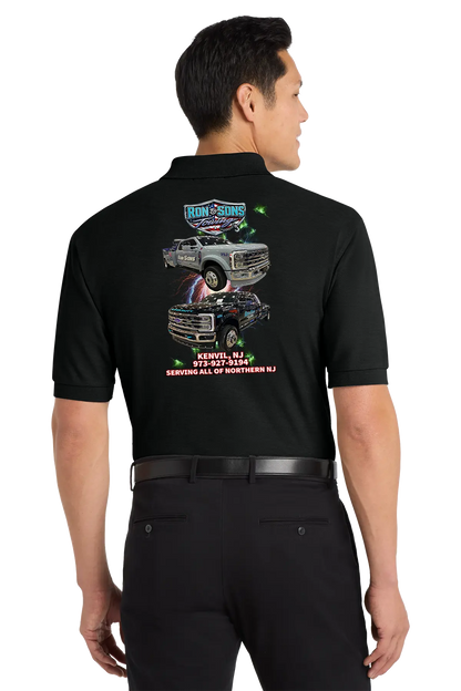 Person wearing a black shirt with graphics and text on the back, standing against a white background. Ron and Sons Towing, Paper Street Print Co, Blairstown, NJ.