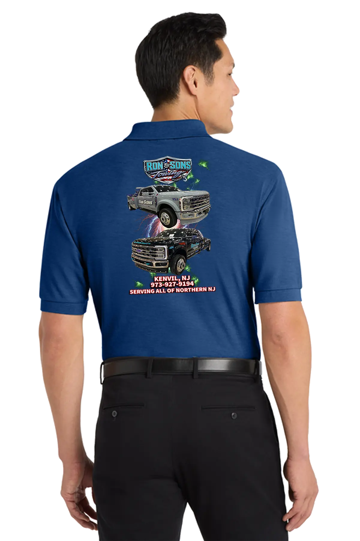 Man wearing a blue polo shirt with graphics and text on the back, standing against a white background. Ron and Sons Towing, Paper Street Print Co, Blairstown, NJ.

