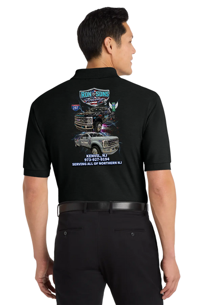 Person wearing a black shirt with graphics and text on the back, standing against a white background. Ron and Sons Towing, Paper Street Print Co, Blairstown, NJ.