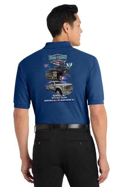 Man wearing a blue shirt with graphics and text on the back, standing against a white background. Ron and Sons Towing, Paper Street Print Co, Blairstown, NJ.