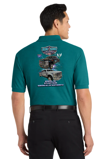 Man wearing a teal shirt with truck graphics and text on the back. Ron and Sons Towing, Paper Street Print Co, Blairstown, NJ.