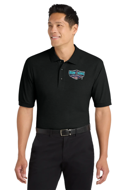 Man wearing a black polo shirt with a logo on a white background. Ron and Sons Towing, Paper Street Print Co, Blairstown, NJ.