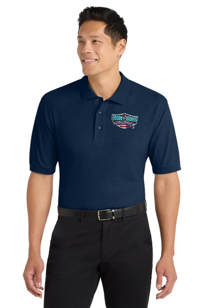 Man wearing a navy blue polo shirt with a logo on a white background. Ron and Sons Towing, Paper Street Print Co, Blairstown, NJ.