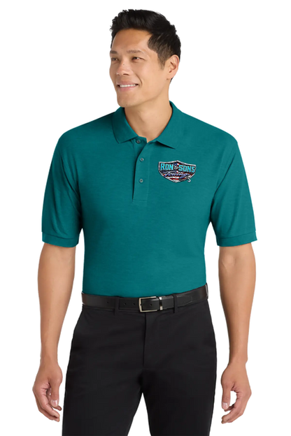 Man wearing a teal polo shirt with a logo on a white background. Ron and Sons Towing, Paper Street Print Co, Blairstown, NJ.