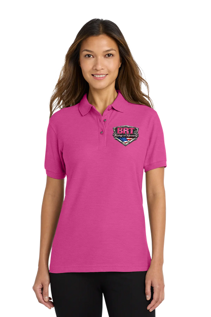 Woman wearing a pink polo shirt with a logo on a white background. BRT Towing & Recovery, Paper Street Print Co, Blairstown, NJ.