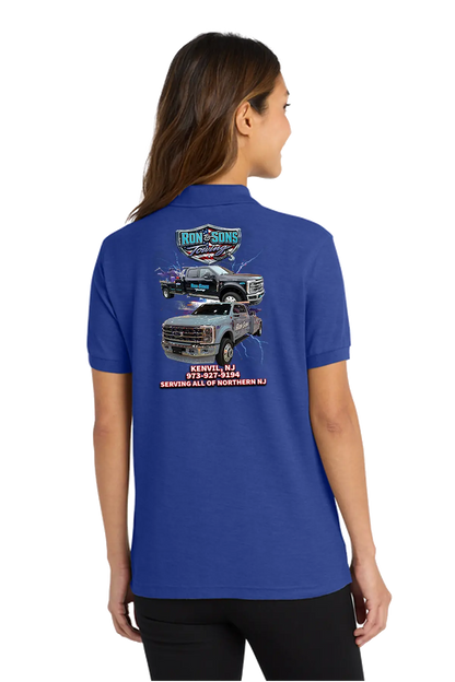 Person wearing a blue polo shirt with a graphic design on the back, standing against a white background. Ron and Sons Towing, Paper Street Print Co, Blairstown, NJ.