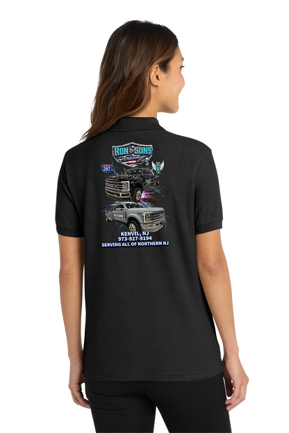 Black polo shirt with graphics and text on the back, worn by a person. Ron and Sons Towing, Paper Street Print Co, Blairstown, NJ.