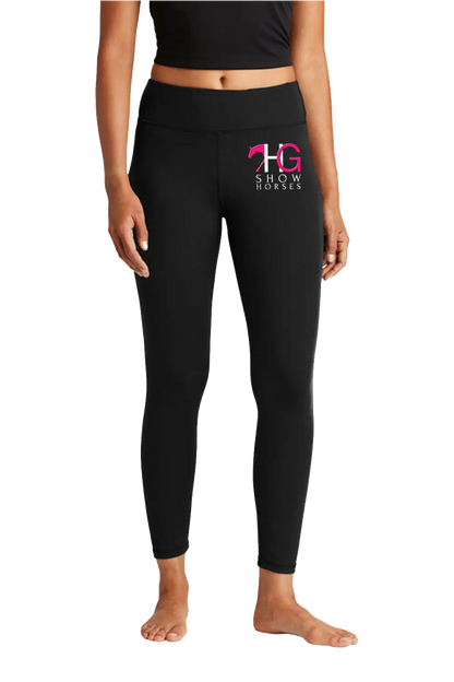 Black high-waisted leggings with a pink and white 'HG Show Horses' logo on the left thigh, modeled on a person against a white background. HG Show Horses, Paper Street Print Co, Blairstown, NJ.