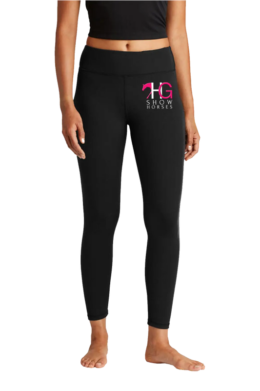 Black high-waisted leggings with a pink and white 'HG Show Horses' logo on the left thigh, modeled on a person against a white background. HG Show Horses, Paper Street Print Co, Blairstown, NJ.
