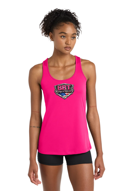 Woman wearing a bright pink tank top with a logo on a white background. BRT Towing and Recovery, Paper Street Print Co, Blairstown, NJ.