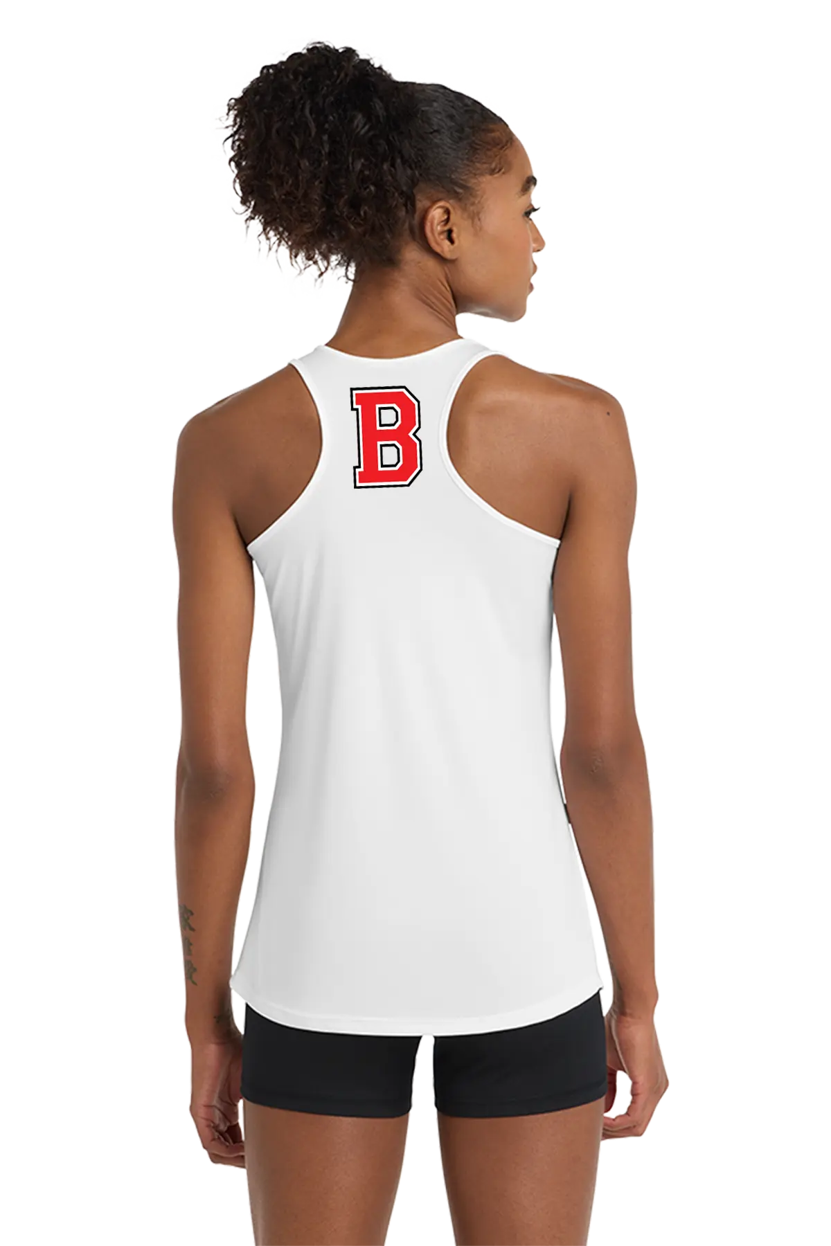 A woman shown from the back wearing a white racerback tank top with a red block letter 'B' on the upper back, paired with black athletic shorts, against a plain white background. Belvidere Lady Seaters Basketball, Paper Street Print Co, Blairstown, NJ.