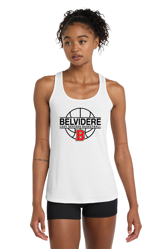 A woman modeling a white racerback tank top with a black and red Belvidere Lady Seaters Basketball logo on the chest, paired with black athletic shorts, against a plain white background. Paper Street Print Co, Blairstown, NJ.