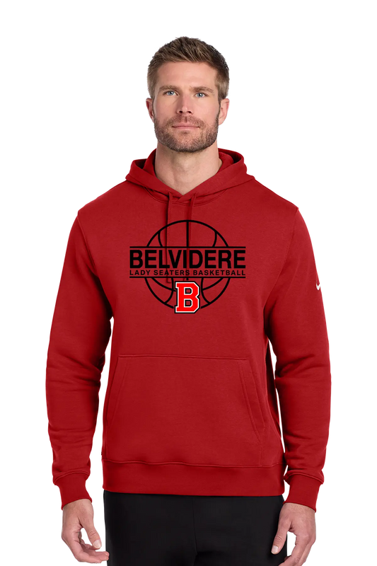 A man wearing a red pullover hoodie with a black and red 'BELVIDERE LADY SEATERS BASKETBALL' graphic and a red 'B' logo on the chest, paired with black pants, against a plain white background. Paper Street Print Co, Blairstown, NJ.