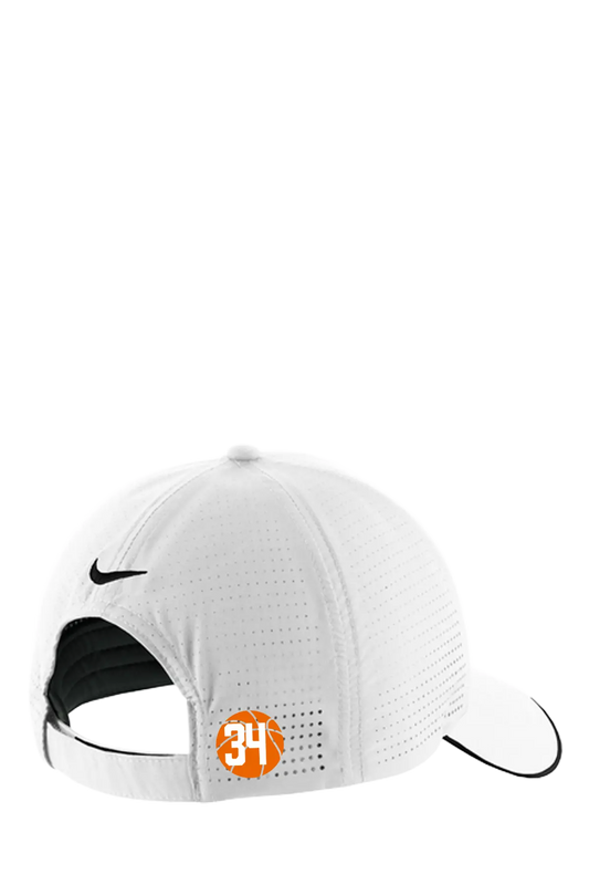 White Nike performance baseball cap shown from the back, featuring a black swoosh logo, a black interior lining, and an orange circular patch with the number 34. Belvidere Lady Seaters Basketball, Paper Street Print Co, Blairstown, NJ.
