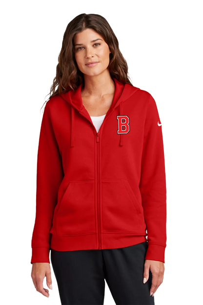 A woman wearing a red full-zip hoodie with a white embroidered letter 'B' on the left chest and a white Nike swoosh on the right sleeve, paired with black pants, against a plain white background. Blairstown Lady Seaters Basketball, Paper Street Print Co, Blairstown, NJ.