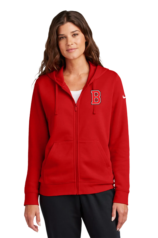 A woman wearing a red full-zip hoodie with a white embroidered letter 'B' on the left chest and a white Nike swoosh on the right sleeve, paired with black pants, against a plain white background. Blairstown Lady Seaters Basketball, Paper Street Print Co, Blairstown, NJ.