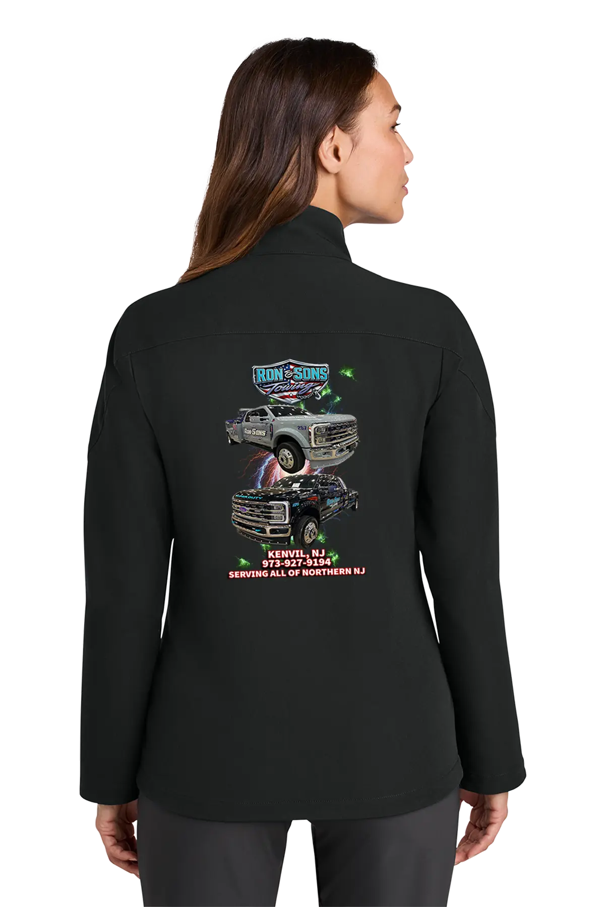 Person wearing a black jacket with a graphic design on the back, standing against a white background. Ron and Sons Towing, Paper Street Print Co, Blairstown, NJ.