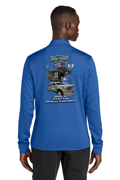 Person wearing a blue long-sleeve shirt with graphics and text on the back, on a white background. Ron and Sons Towing, Paper Street Print Co, Blairstown, NJ.