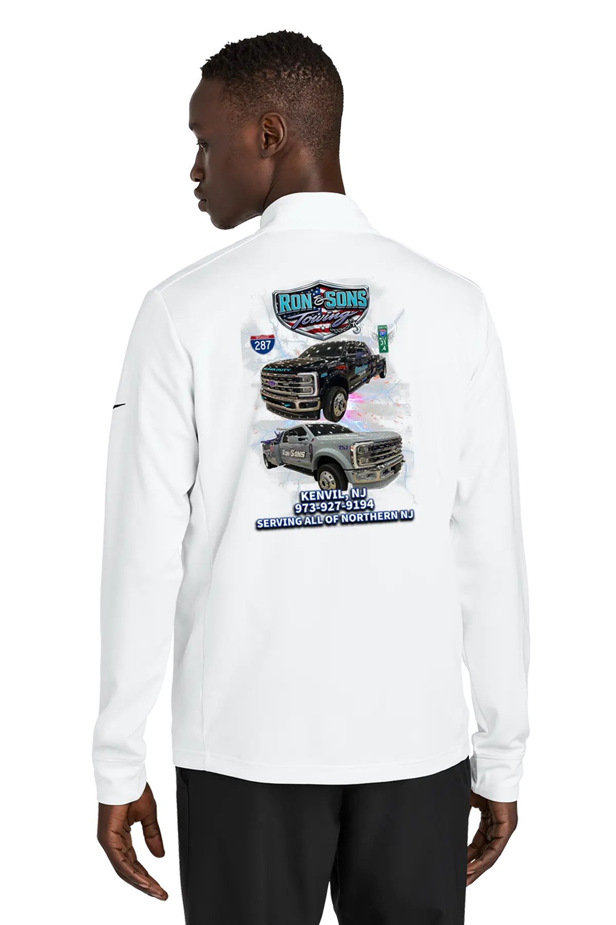 Person wearing a white long-sleeve shirt with graphic designs on the back, standing against a white background. Ron and Sons Towing, Paper Street Print Co, Blairstown, NJ.