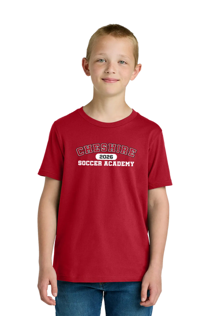 Child wearing a red t-shirt with 'Cheshire Soccer Academy 2023' text on a white background. Paper Street Print Co, Blairstown, NJ.