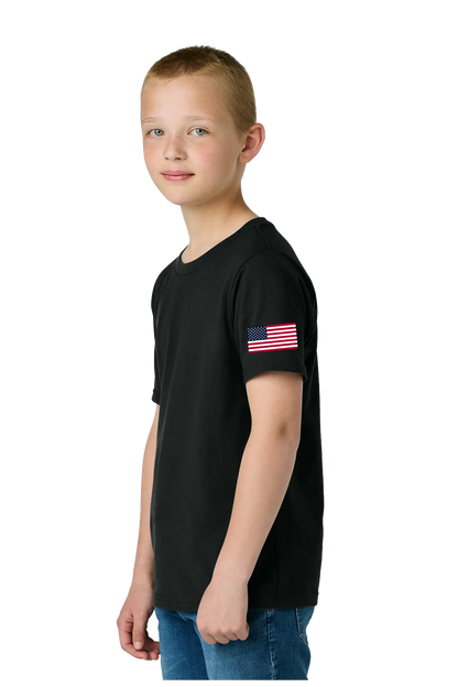 Young boy wearing a black t-shirt with an American flag on a white background. #JusticeforDJ - Paper Street Print Co, Blairstown, NJ.