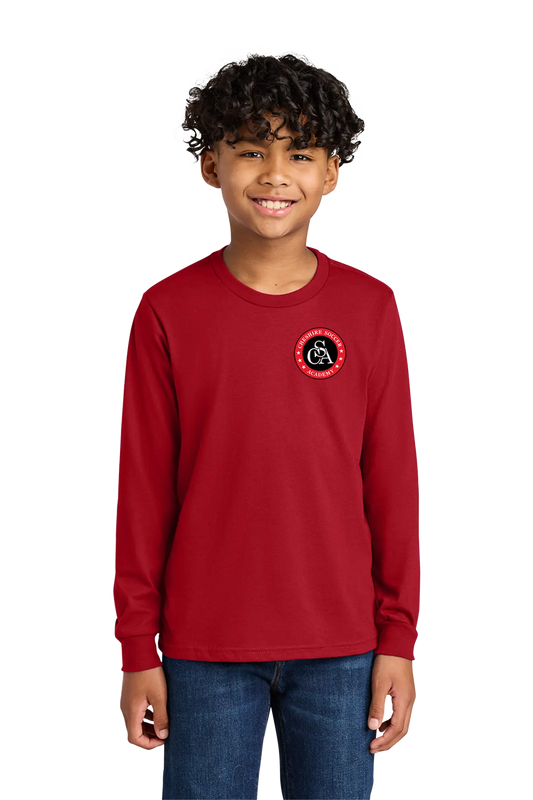 Child wearing a red long-sleeve shirt with a logo on a white background. Paper Street Print Co, Blairstown, NJ.