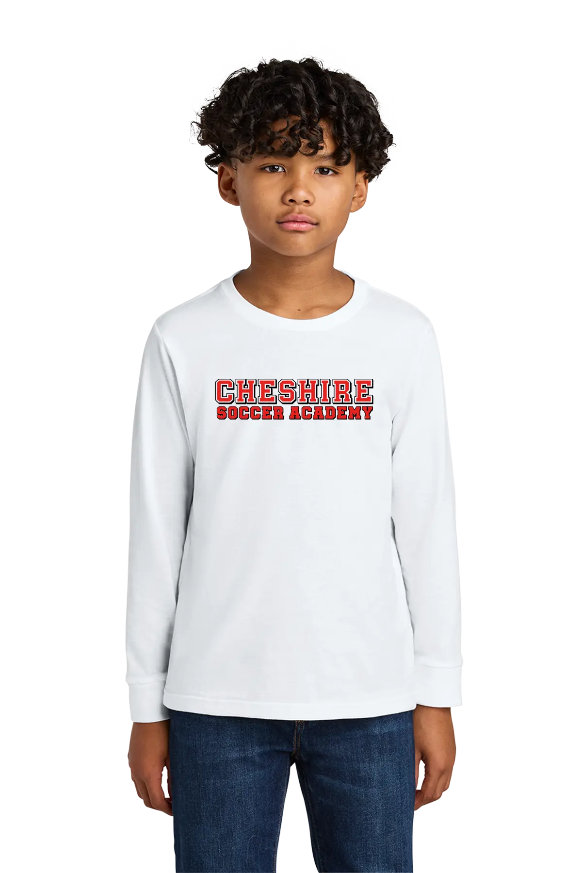 Child wearing a white long-sleeve shirt with 'Cheshire Soccer Academy' text on a white background. Paper Street Print Co, Blairstown, NJ.