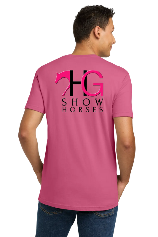 A man wearing a pink t-shirt from the back, featuring a large graphic print of a horse silhouette and the letters 'HG' with 'SHOW HORSES' underneath in black and pink. He is also wearing blue jeans against a plain white background. HG Show Horses, Paper Street Print Co, Blairstown, NJ.