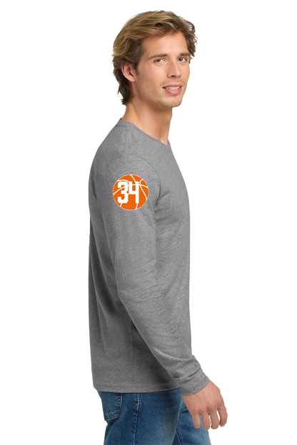 Man wearing a gray long-sleeve shirt with a logo on the sleeve against a white background