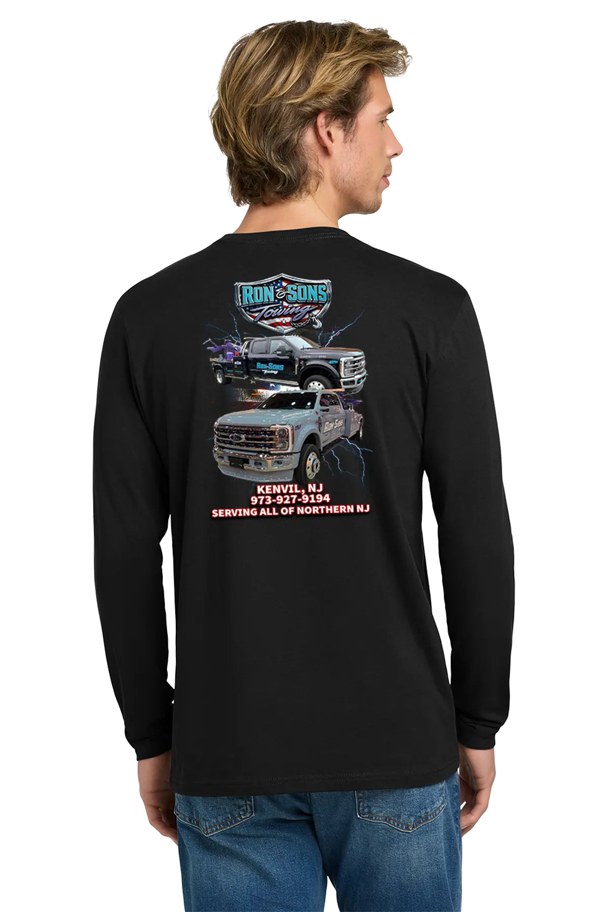 Person wearing a black long-sleeve shirt with graphics and text on the back, standing against a white background. Ron and Sons Towing, Paper Street Print Co, Blairstown, NJ.