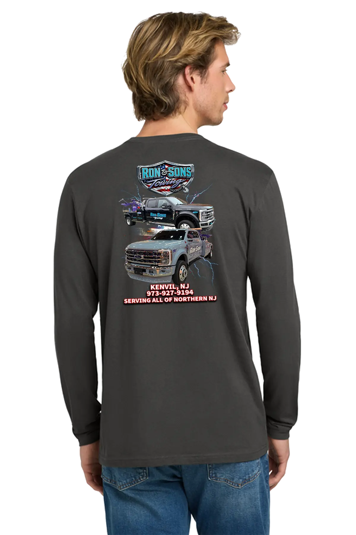Person wearing a black long-sleeve shirt with graphics and text on the back, standing against a white background. Ron and Sons Towing, Paper Street Print Co, Blairstown, NJ.