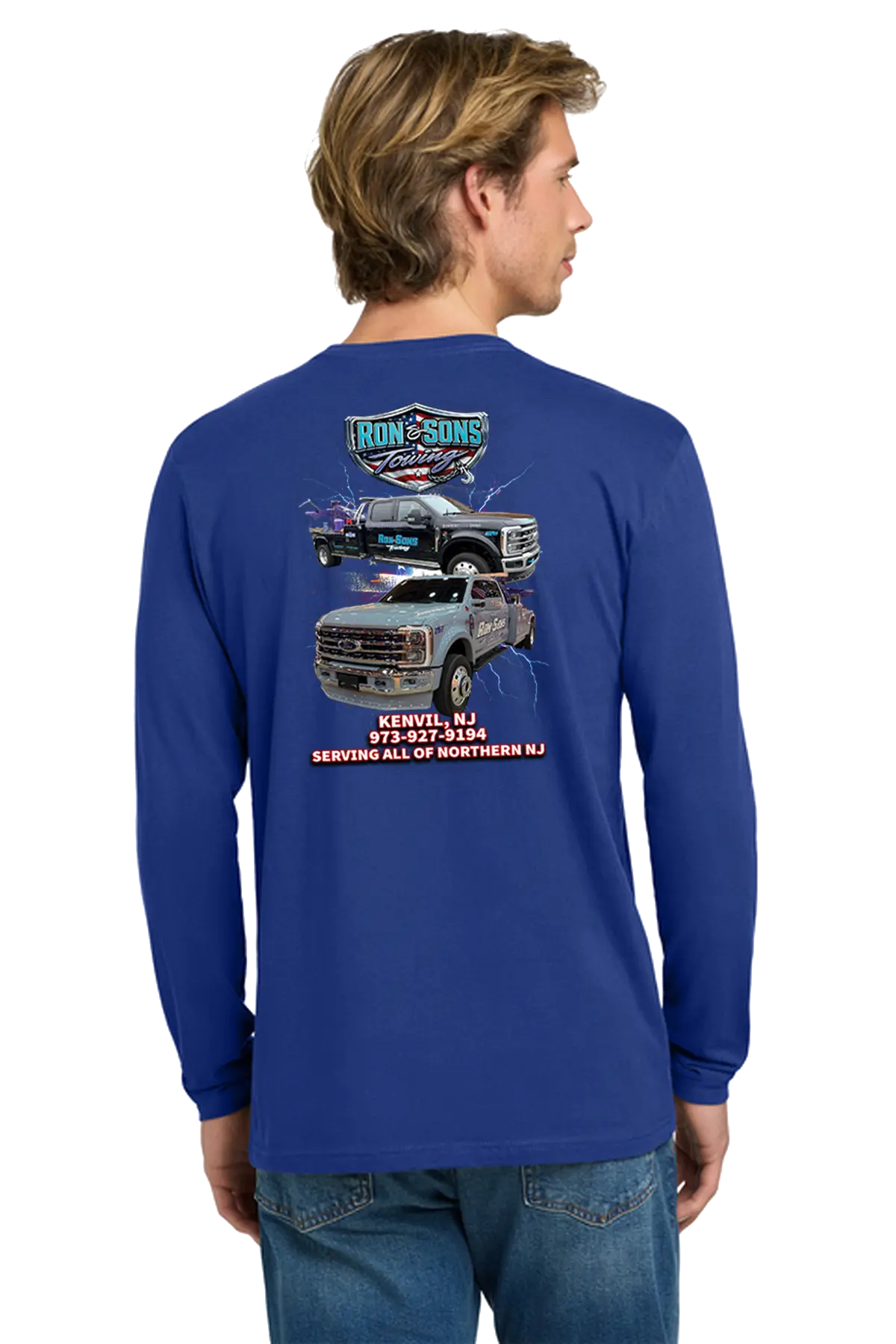 Person wearing a blue long-sleeve shirt with a graphic of trucks and text on the back. Ron and Sons Towing, Paper Street Print Co, Blairstown, NJ.