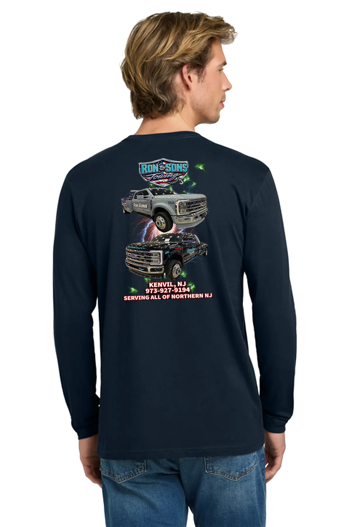 Person wearing a navy long-sleeve shirt with graphics and text on the back, standing against a white background. Ron and Sons Towing, Paper Street Print Co, Blairstown, NJ.