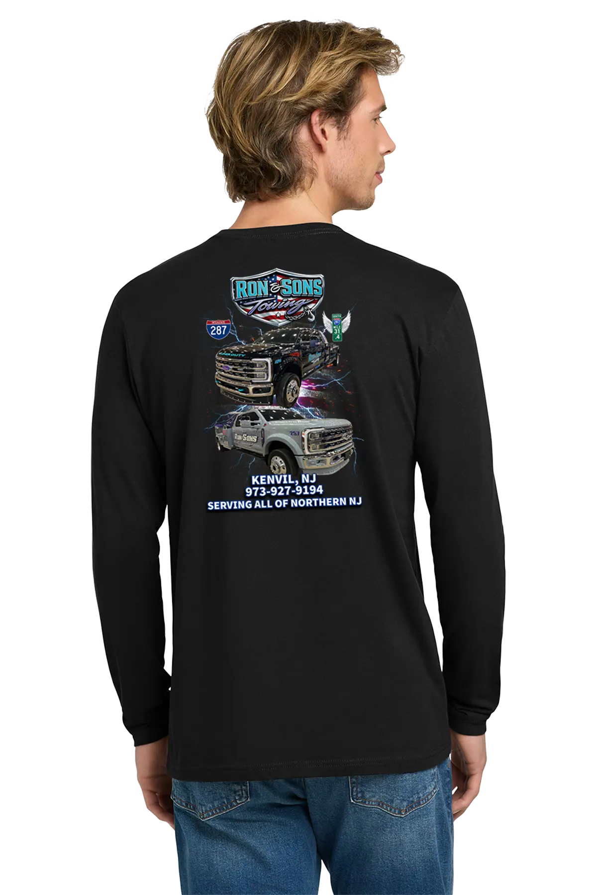 Person wearing a black long-sleeve shirt with graphics and text on the back, standing against a white background. Ron and Sons Towing, Paper Street Print Co, Blairstown, NJ.