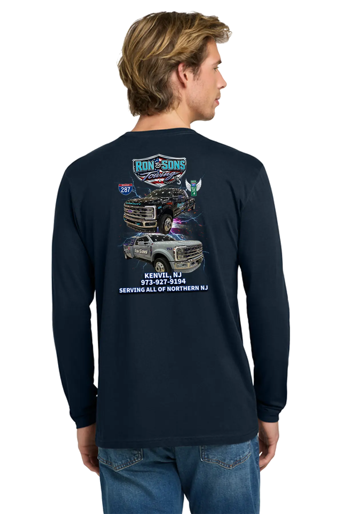 Man wearing a navy long-sleeve shirt with graphics and text on the back, standing against a white background. Ron and Sons Towing, Paper Street Print Co, Blairstown, NJ.