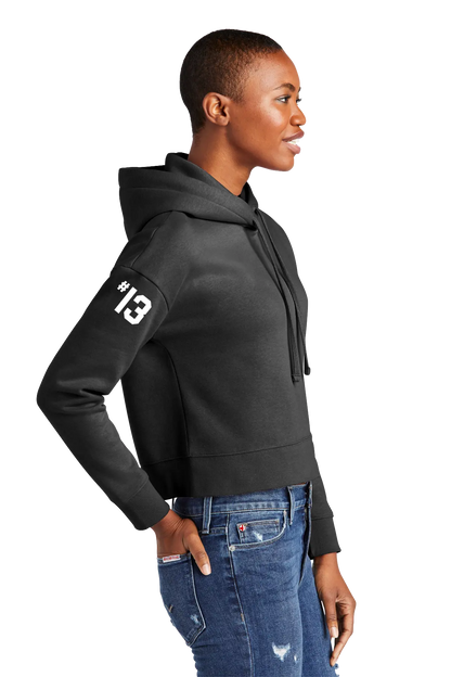 Person wearing a black hoodie with a white number '13' on the sleeve, standing against a white background. Paper Street Print Co, Blairstown, NJ.