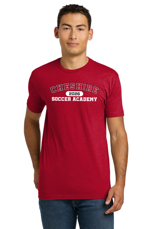 Man wearing a red t-shirt with 'Cheshire Soccer Academy 2026' text on a white background. Paper Street Print Co, Blairstown, NJ.