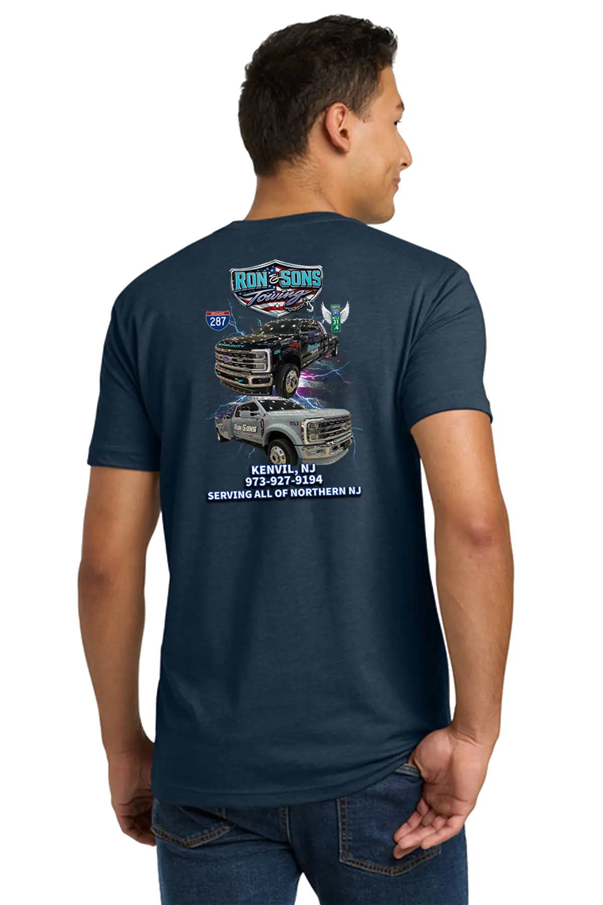 Person wearing a navy blue t-shirt with graphics and text on the back, on a white background. Ron and Sons Towing, Paper Street Print Co, Blairstown, NJ.