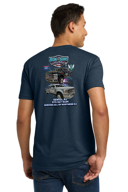 Person wearing a navy blue t-shirt with graphics and text on the back, on a white background. Ron and Sons Towing, Paper Street Print Co, Blairstown, NJ.