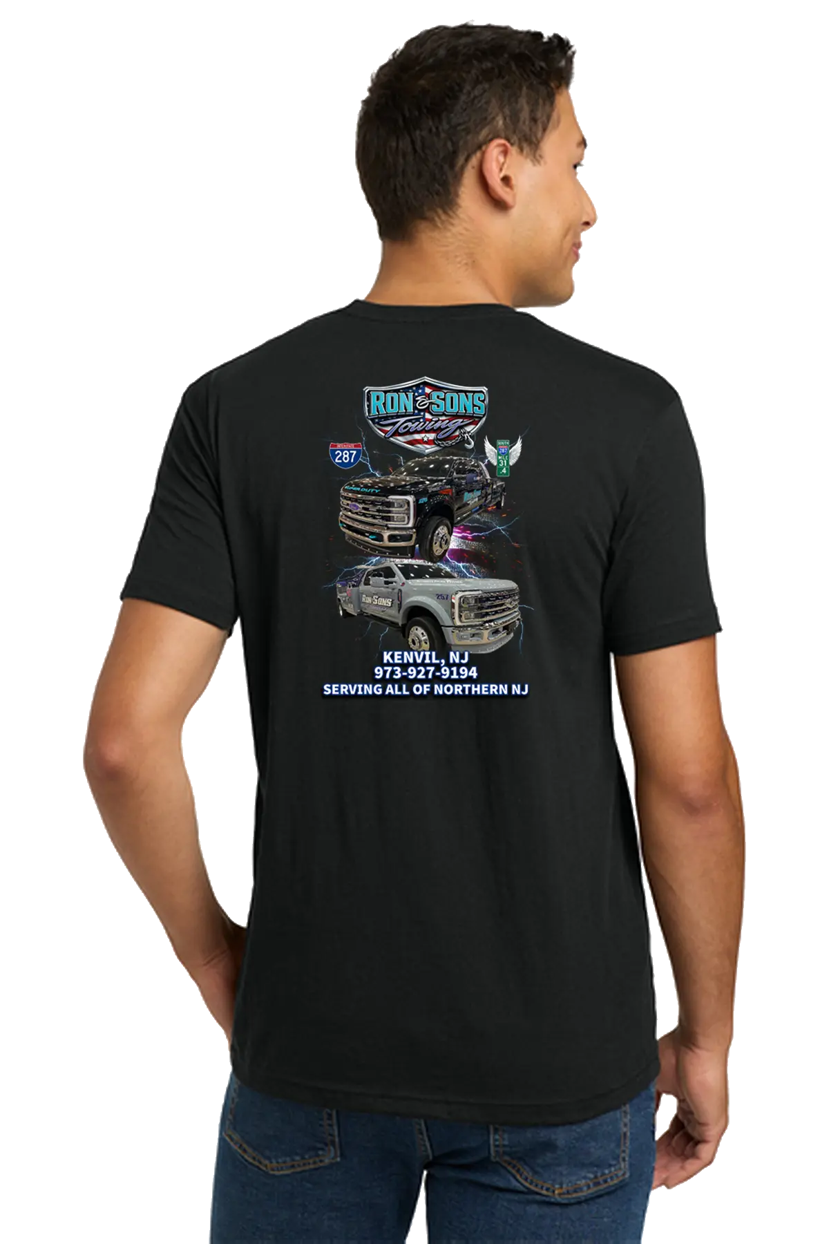 Man wearing a black t-shirt with a graphic design on the back, standing against a white background. Ron & Sons Towing, Paper Street Print Co, Blairstown, NJ.