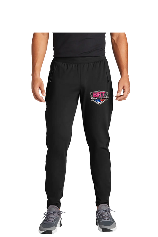 Black jogger pants with a logo on the left leg, worn by a person on a white background. BRT Towing and Recovery, Paper Street Print Co, Blairstown, NJ.