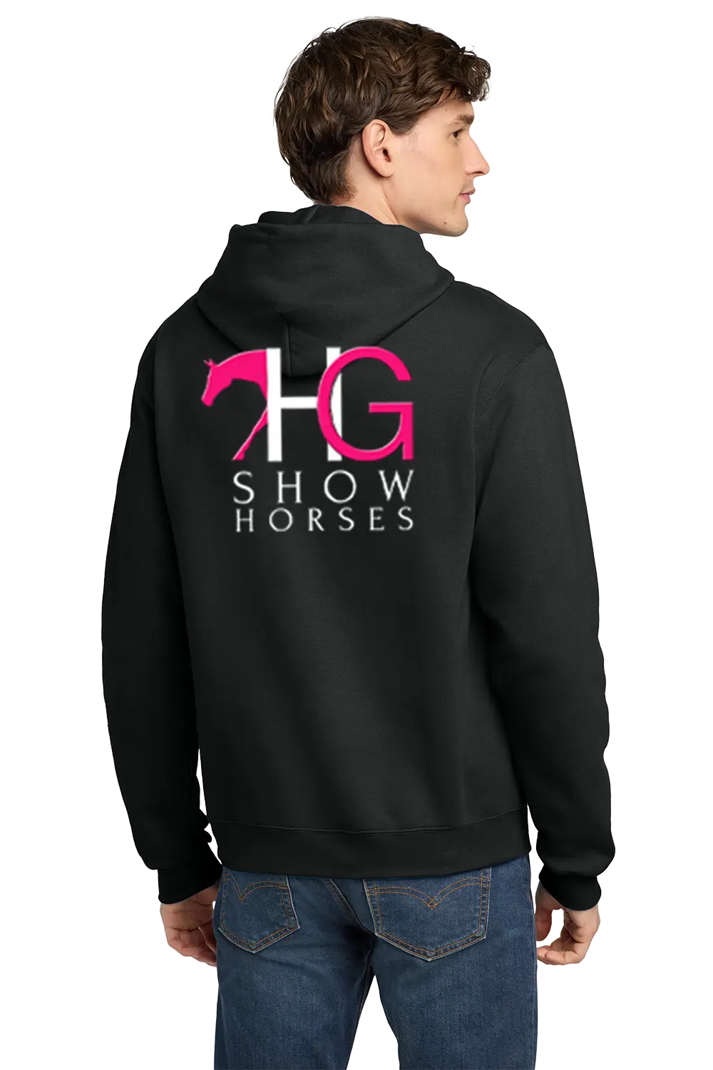 A man wearing a black hoodie from the back, featuring a large graphic on the back with a pink horse silhouette, the letters 'HG' in white and pink, and the words 'SHOW HORSES' in white. He is also wearing blue jeans, set against a plain white background. HG Show Horses, Paper Street Print Co, Blairstown, NJ.