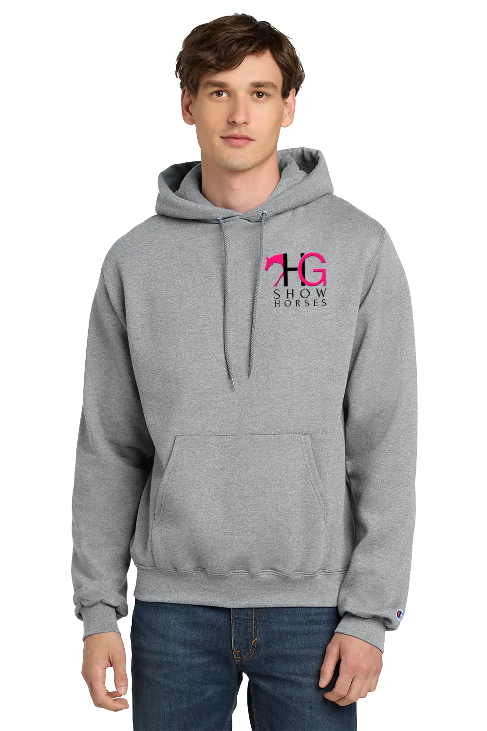 A man wearing a heather gray pullover hoodie with a pink and black 'HG Show Horses' logo on the left chest, paired with blue jeans, against a plain white background. HG Show Horses, Paper Street Print Co, Blairstown, NJ.