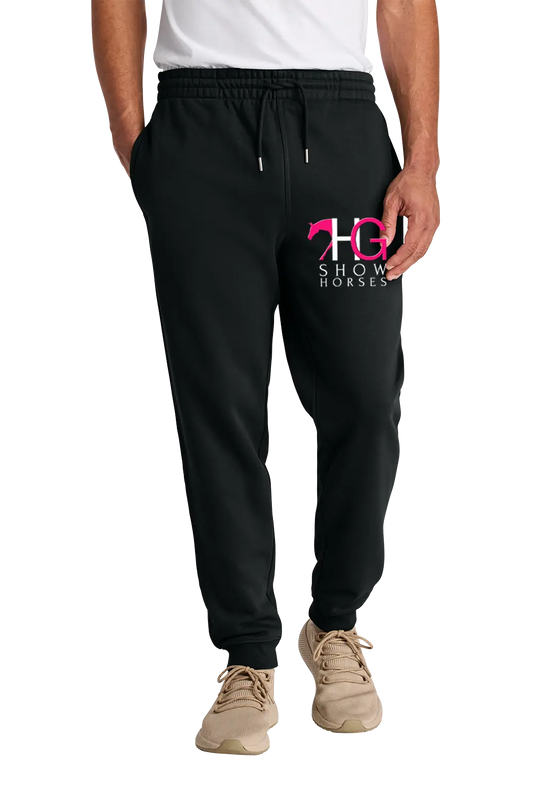 A person wearing black jogger sweatpants with a pink and white 'HC Show Horses' logo on the left thigh, paired with a white t-shirt and beige sneakers, shown from the waist down on a white background. HG Show Horses, Paper Street Print Co, Blairstown, NJ.