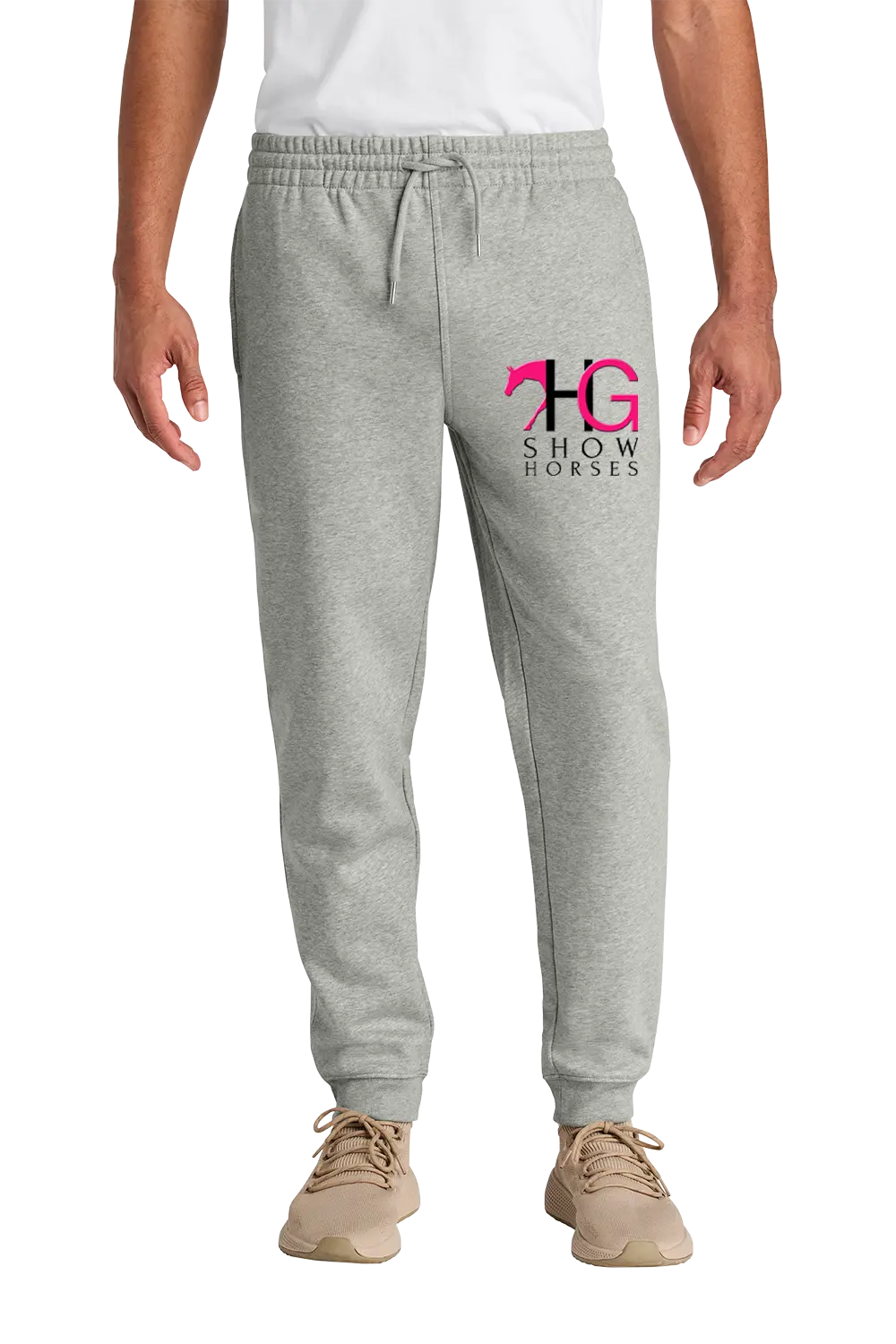 A person wearing light heather gray jogger sweatpants with a pink and black 'HG Show Horses' logo on the left thigh, paired with a white shirt and tan sneakers, shown against a plain white background. HG Show Horses, Paper Street Print Co, Blairstown, NJ.