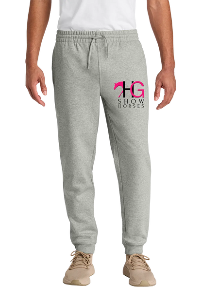 A person wearing light heather gray jogger sweatpants with a pink and black 'HG Show Horses' logo on the left thigh, paired with a white shirt and tan sneakers, shown against a plain white background. HG Show Horses, Paper Street Print Co, Blairstown, NJ.