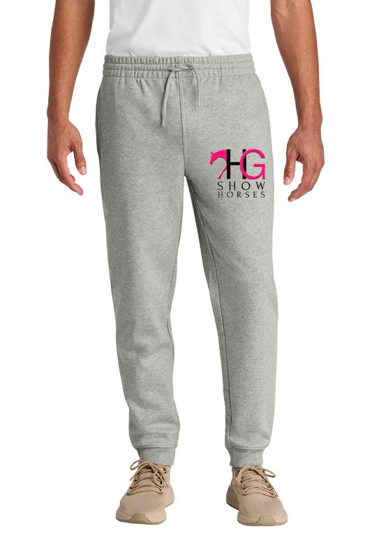 A person wearing light heather gray jogger sweatpants with a pink and black 'HG Show Horses' logo on the left thigh, paired with a white shirt and tan sneakers, shown against a plain white background. HG Show Horses, Paper Street Print Co, Blairstown, NJ.