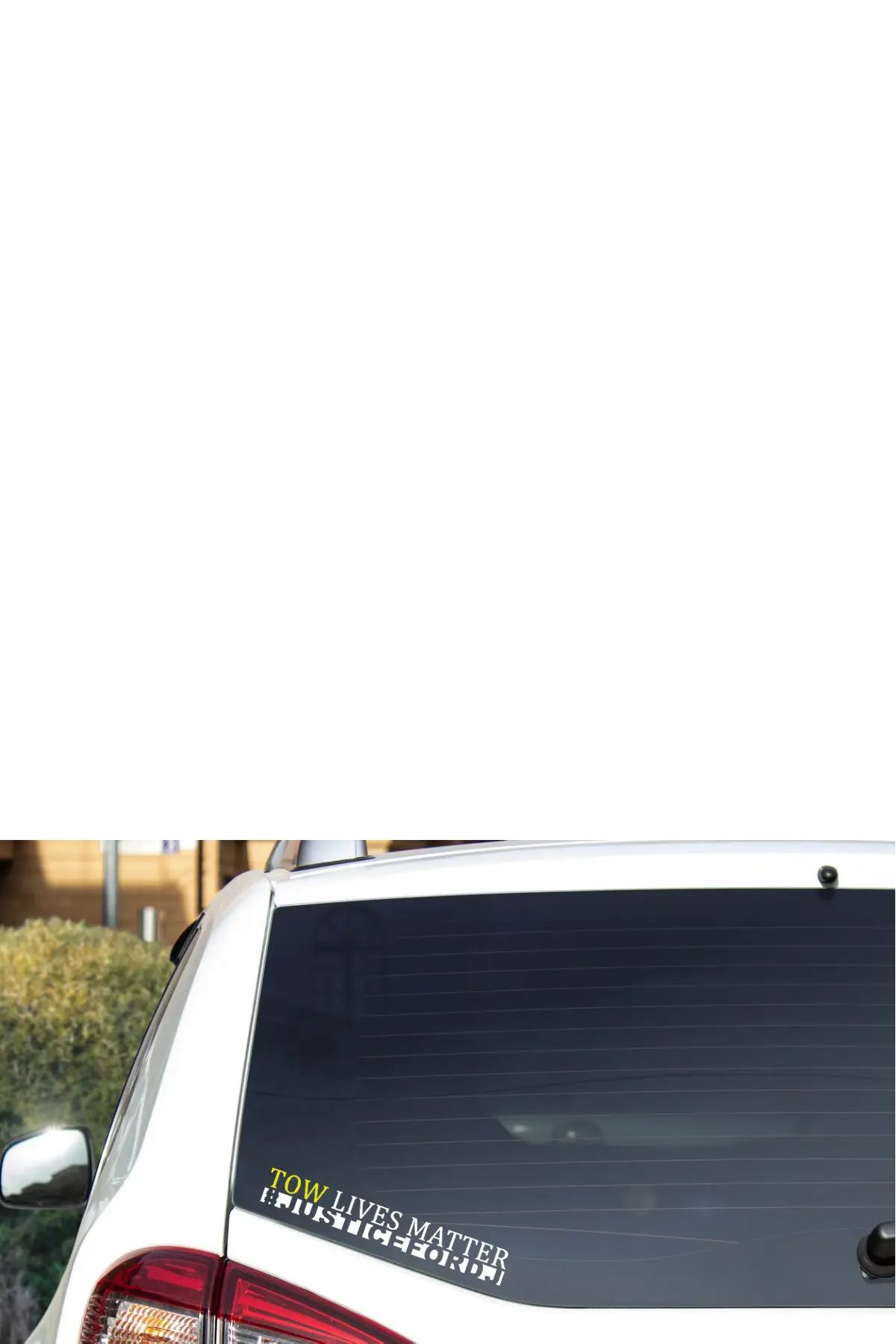 Car with a decal on the back window, featuring text saying TOW LIVES MATTER - JUSTICE FOR DJ - Paper Street Print Co, Blairstown, NJ.